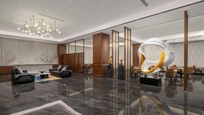 A spacious lobby with a modern chandelier, seating areas, and a large abstract sculpture. - Days Hotel by Wyndham Fuyang Linquan (Fuyang)