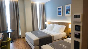 Standard Triple Room | Minibar, in-room safe, desk, blackout drapes