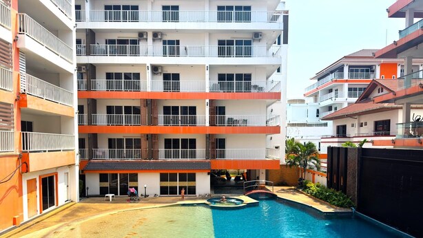 A multi-story hotel with a swimming pool, balconies, and a covered area. - Stylish Pool-view Studio With Balcony - New Nordic VIP 3, Pratumnak (Pattaya)