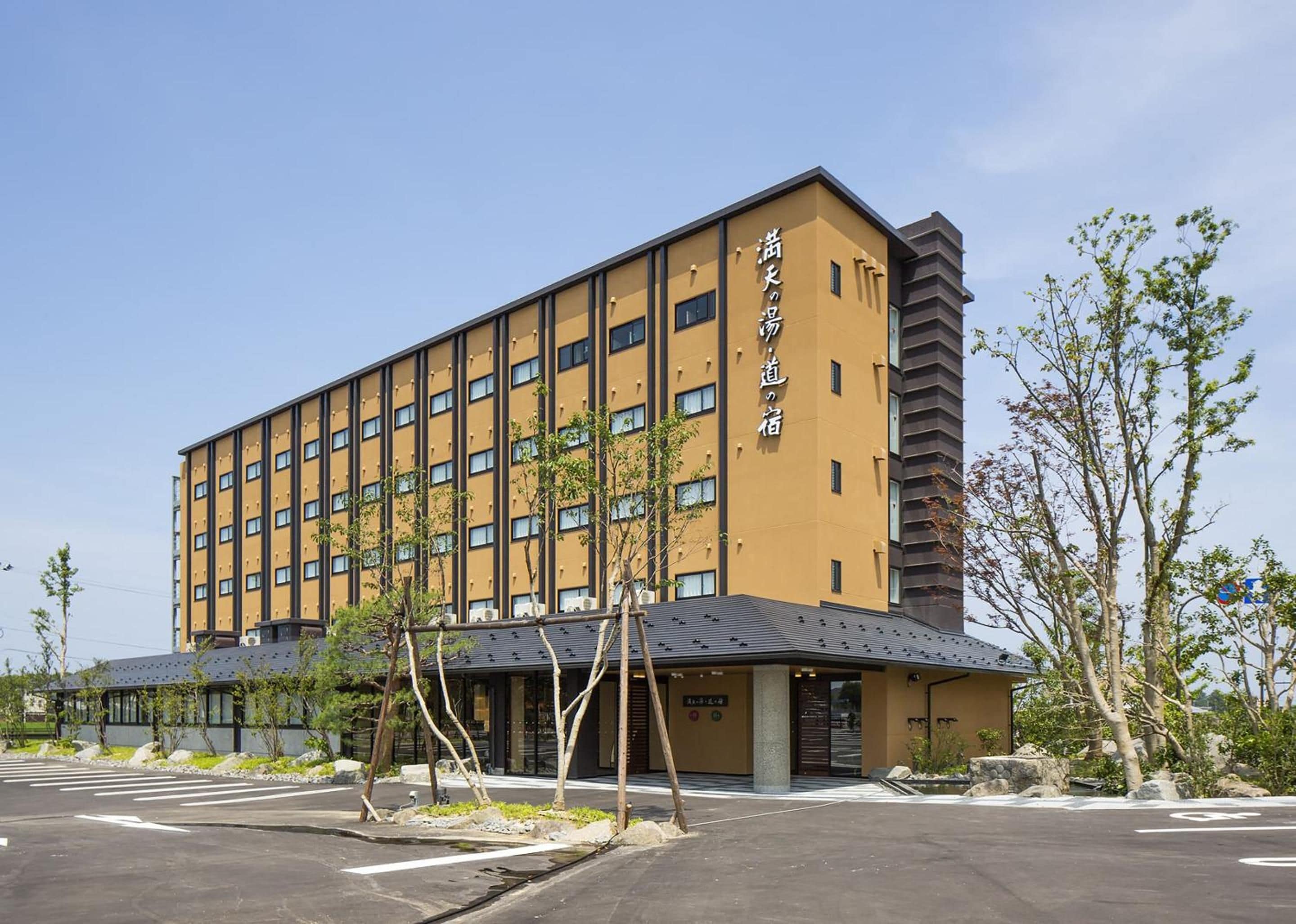 A multi-story hotel with a yellow facade and a modern design.