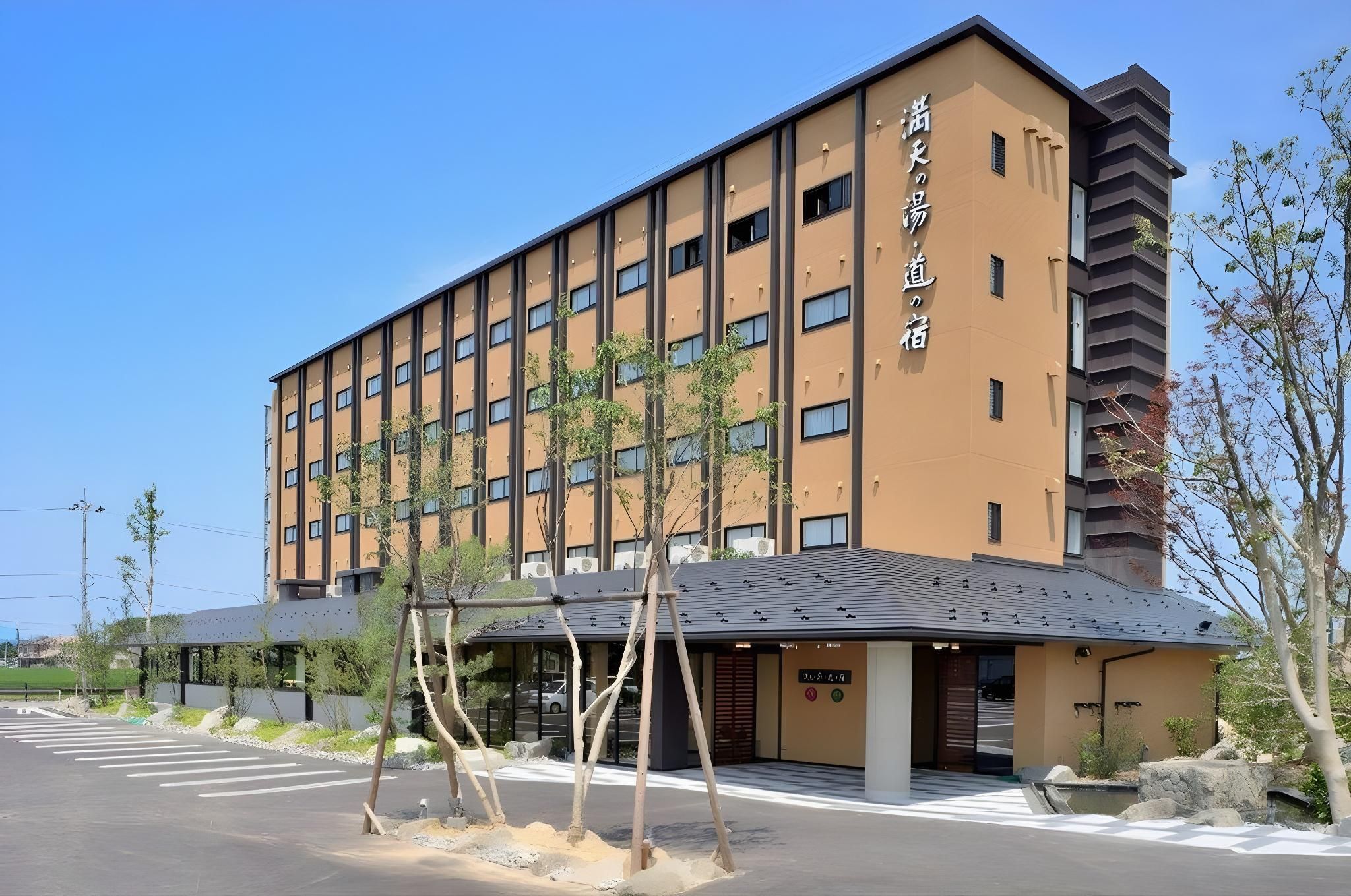 A multi-story hotel with a modern design, featuring a flat roof and a series of windows on each floor.