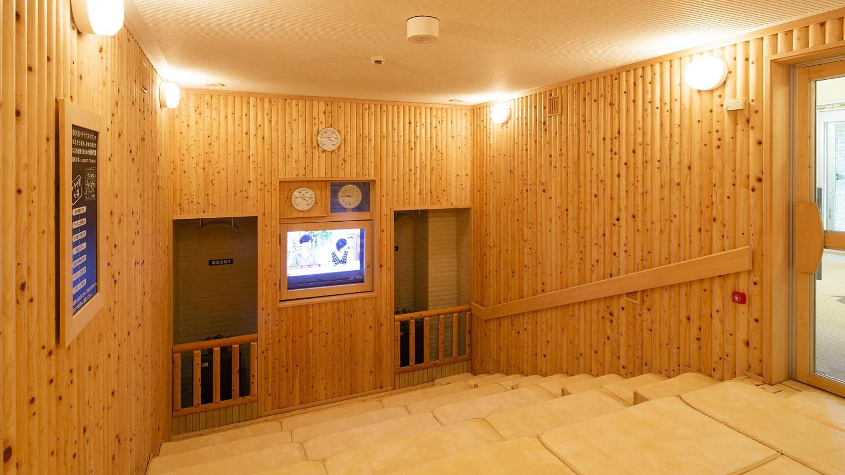 A wooden interior with a staircase, a clock, and a television screen.