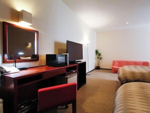 A hotel room with a desk, a television, a red chair, a bed, and a large mirror. - Hotel Livemax Budget Hamamatsu Station (Hamamatsu)