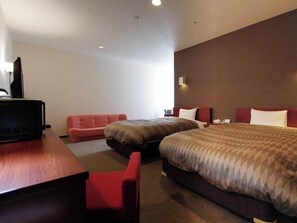 A hotel room with two beds, a desk, and a red chair. - Hotel Livemax Budget Hamamatsu Station (Hamamatsu)