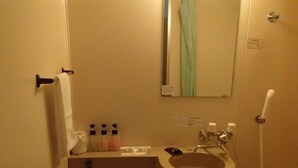 A bathroom with a sink, mirror, and shower. There is a towel rack and a toilet. - Single Inn Niigata No.2 (Niigata)