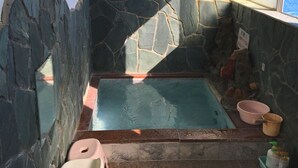 A stone-walled bathtub with a window, a toilet, and a sink. - Kiemonso (Shimoda)