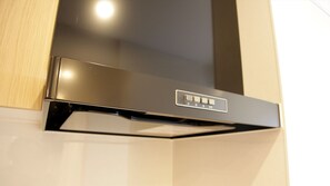 A modern kitchen with a stainless steel range hood and control panel. - Mango Resort Okinawa Naha (Naha)