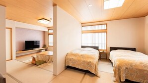A hotel room with two beds, a TV, a small desk, and a window with blinds. - Sakana Asobi No Yado Yamacho (Fukui)
