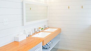 A modern bathroom with two sinks, a large mirror, and a wooden countertop. - Casablanca Vacation House (Tokunoshima)
