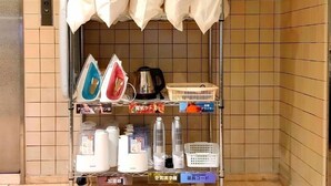 A utility room with ironing boards, a kettle, and storage shelves. - Hotel Mates Ageo (Ageo)