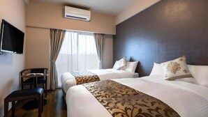 A hotel room with two beds, a flat-screen TV, a desk, and an air conditioning unit. - Mr. Kinjo Link in Kume Naha (Naha)