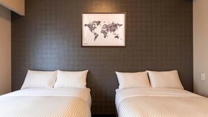 A hotel room with two beds, a world map artwork on the wall, and a dark textured wall. - Mr. Kinjo Link in Kume Naha (Naha)
