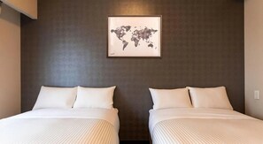A hotel room with two beds, a world map artwork on the wall, and a dark textured wall. - Mr. Kinjo Link in Kume Naha (Naha)