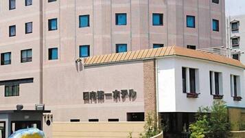 A multi-story building with a sign indicating it is a hotel.