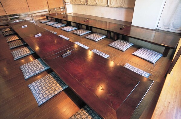 A long conference table with multiple chairs and nameplates, indicating a meeting or conference room setting. - Hyuga Dai-ichi Hotel (Hyuga)