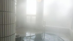 A steam room with a tiled floor and a metal railing. - Yado Atagoya (Fukushima)