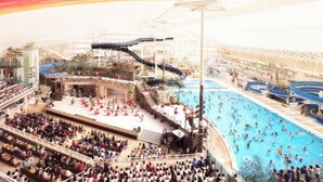 A large indoor swimming pool with multiple lanes and a stage area for performances. - Hotel Hamatoku (Iwaki)