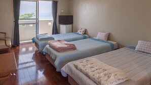 A hotel room with two beds, a desk, and a window with curtains. - Uminchuno Yado (Nago)