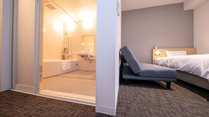 A hotel room with a shower, sink, and a bed. - Best Price Kochi (Kochi)
