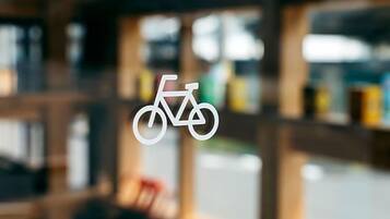A blurred interior view of a building with a bicycle symbol on a window.