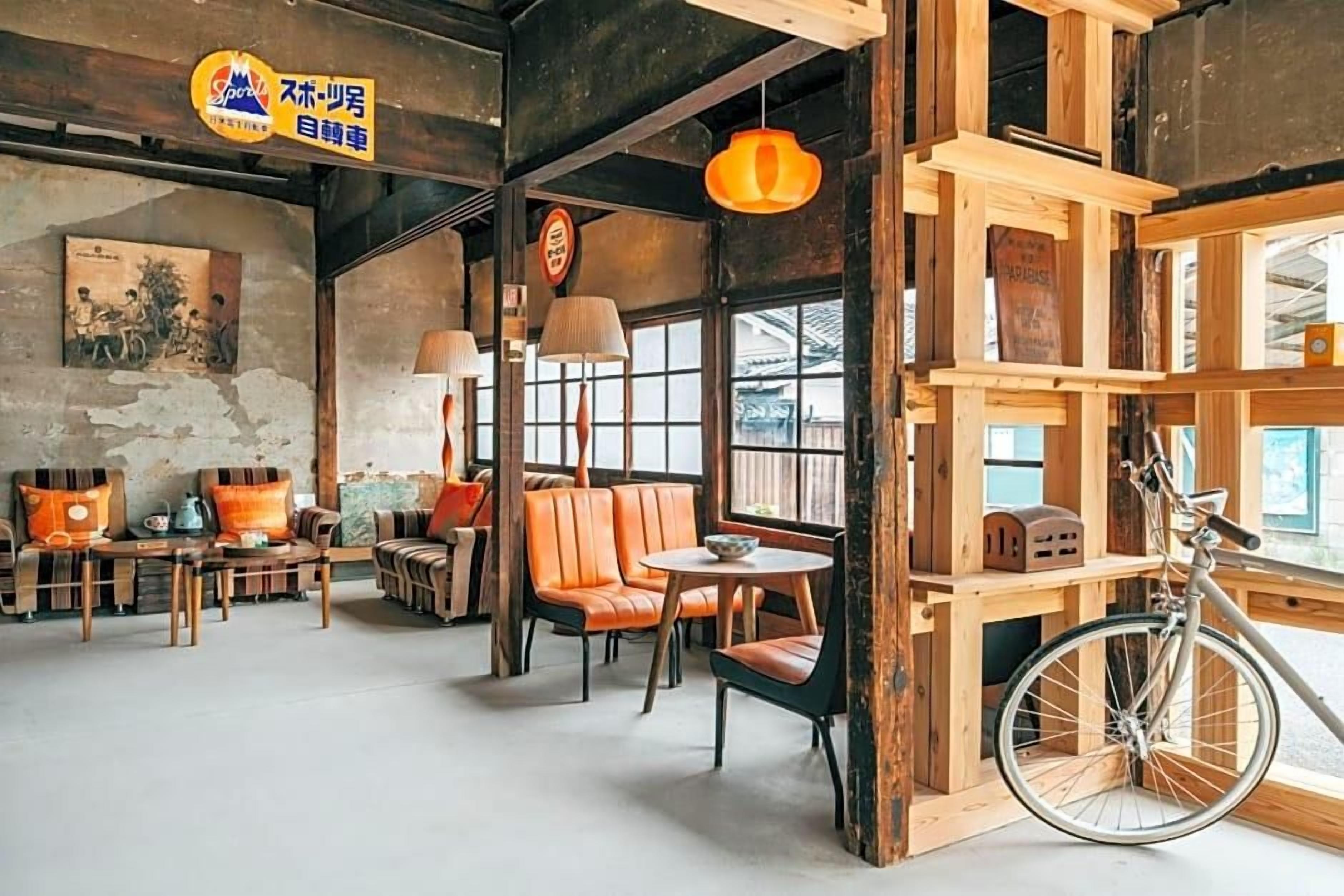 A cozy cafe with wooden furniture, a bicycle, and a rustic decor.