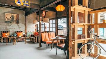 A cozy cafe with wooden furniture, a bicycle, and a rustic decor.