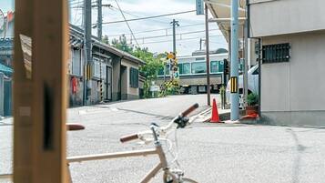 A bicycle parked on a street with a train in the background.