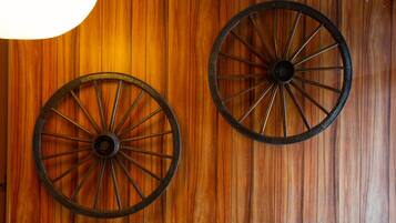 Two large wooden wheels mounted on a wall.