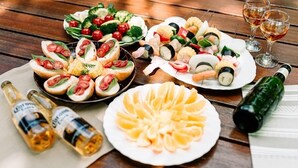 A variety of food items and drinks on a wooden table. - Canadian Village Montreal (Omachi)