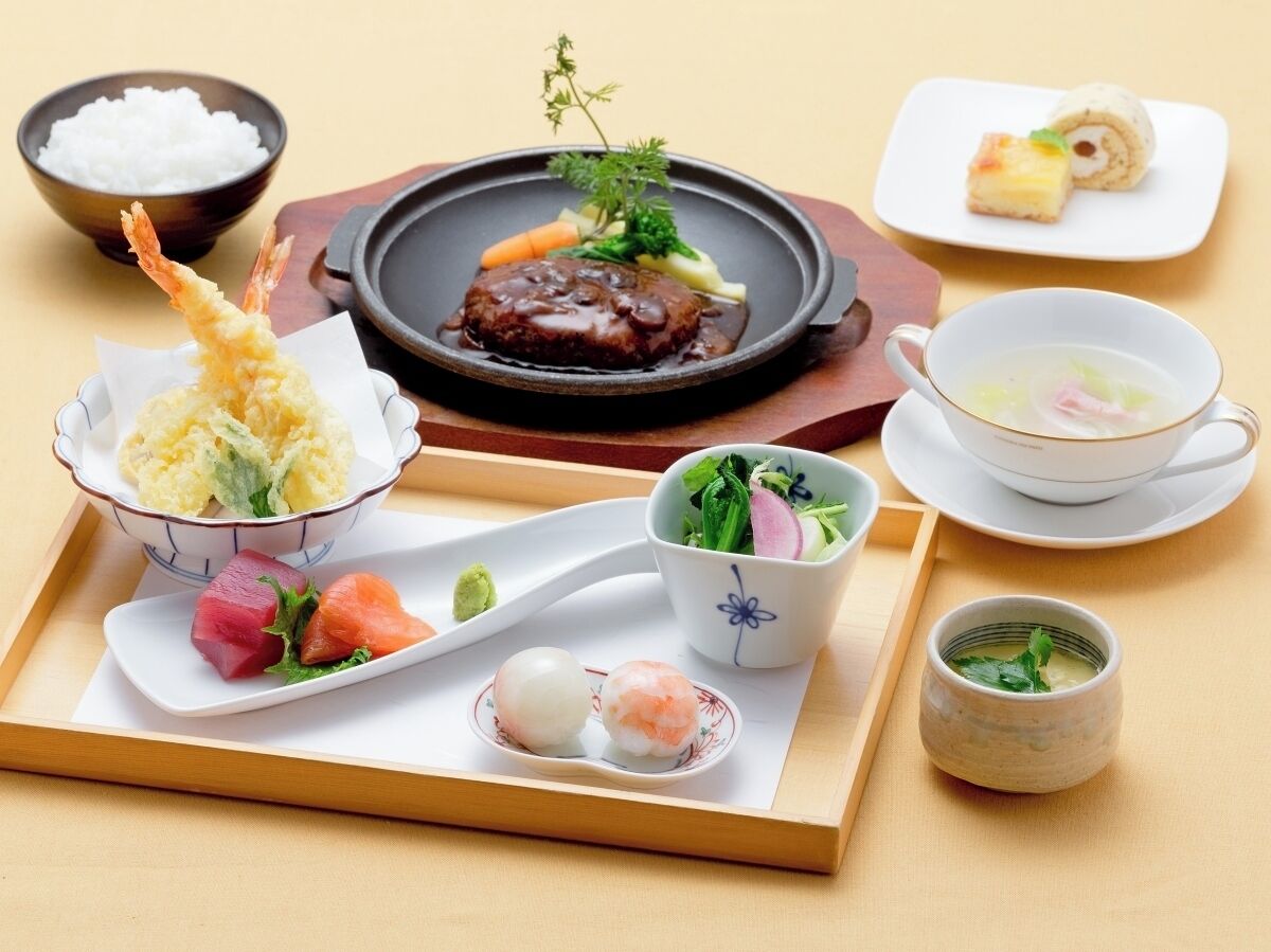 A variety of Japanese dishes including sushi, tempura, and a bowl of rice.