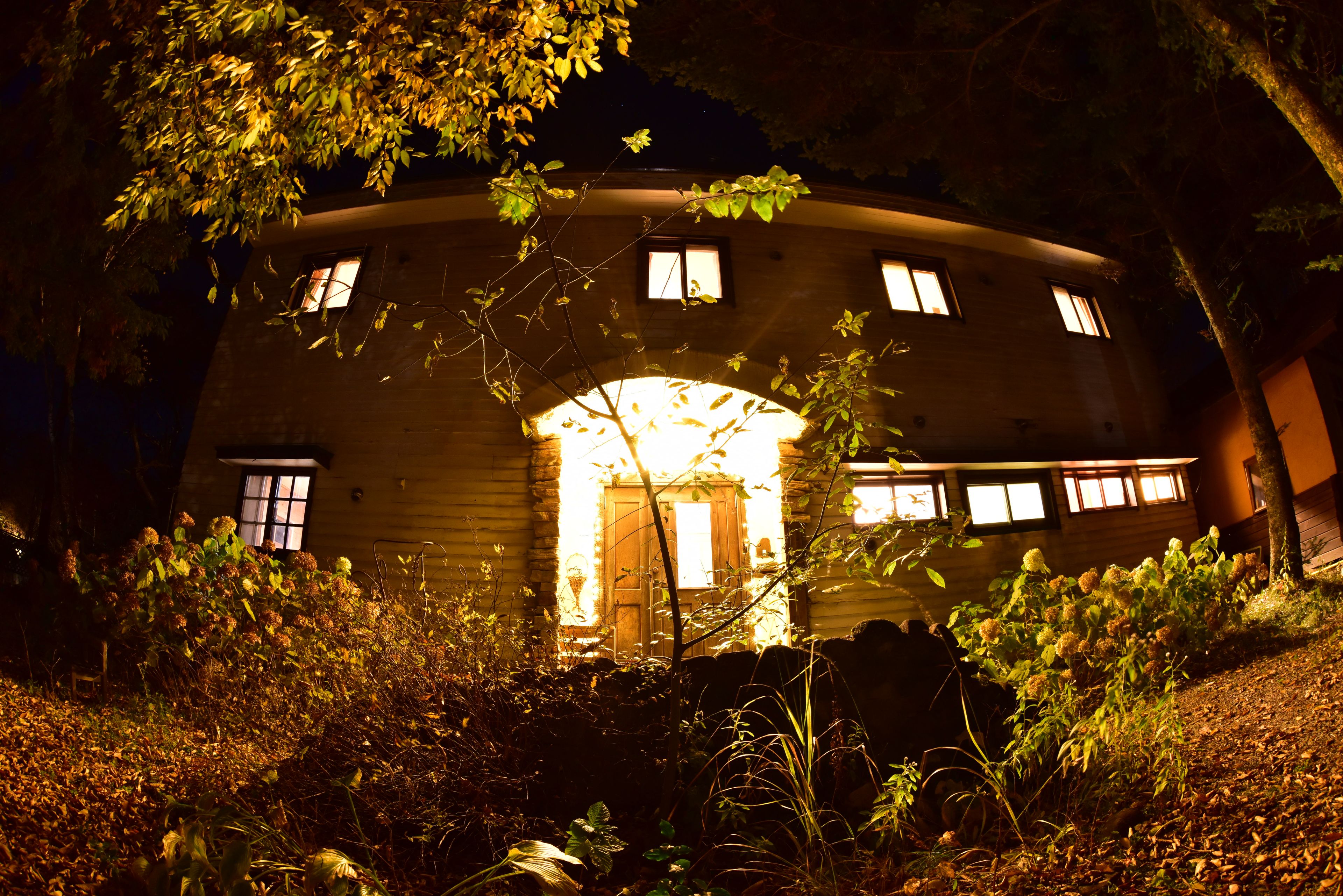 A circular building with a central entrance and multiple windows.