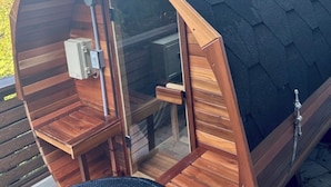 A wooden cabin with a small kitchenette, a window, and a door. - Okutass Resort Villa Terra (Awaji)