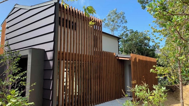 A modern building with a sloped roof and a wooden fence. - Okutass Resort Villa Terra (Awaji)