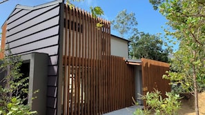 A modern building with a sloped roof and a wooden fence. - Okutass Resort Villa Terra (Awaji)