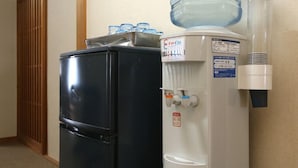 A water dispenser and a refrigerator in a hallway. - Annex Kawanatsu (Shinonsen)