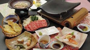 A hot pot setup with various ingredients and condiments. - Dog's Rest Place (Hakone)
