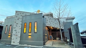 A building with a unique facade featuring protruding elements and illuminated windows. - Noichi (Toba)