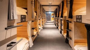 A corridor with bunk beds, each labeled with room numbers. - Ping Pong Hotel & Cabin Tokuyama Ekimae / Ping Pong Residence Kojimachi (Shunan)