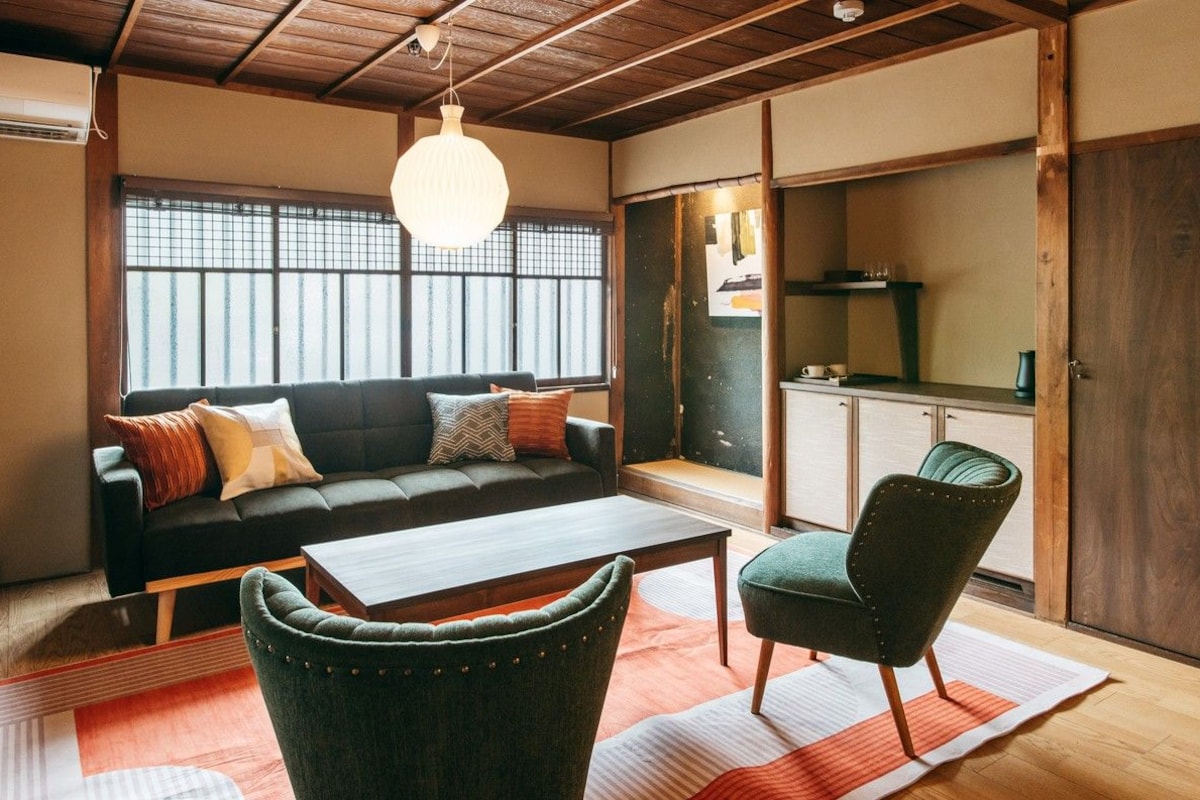 A traditional Japanese-style living room with a sofa, a coffee table, and a chair.