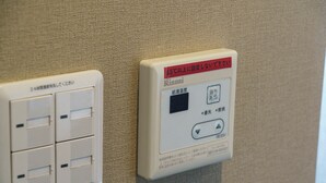 A wall-mounted electrical panel with multiple switches and a digital display. - Mr. Kinjo Violette Kukomae (Naha)