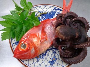 A plate with a whole fish, octopus, and parsley. - Izu Shimoda Minshuku Sangenya (Shimoda)