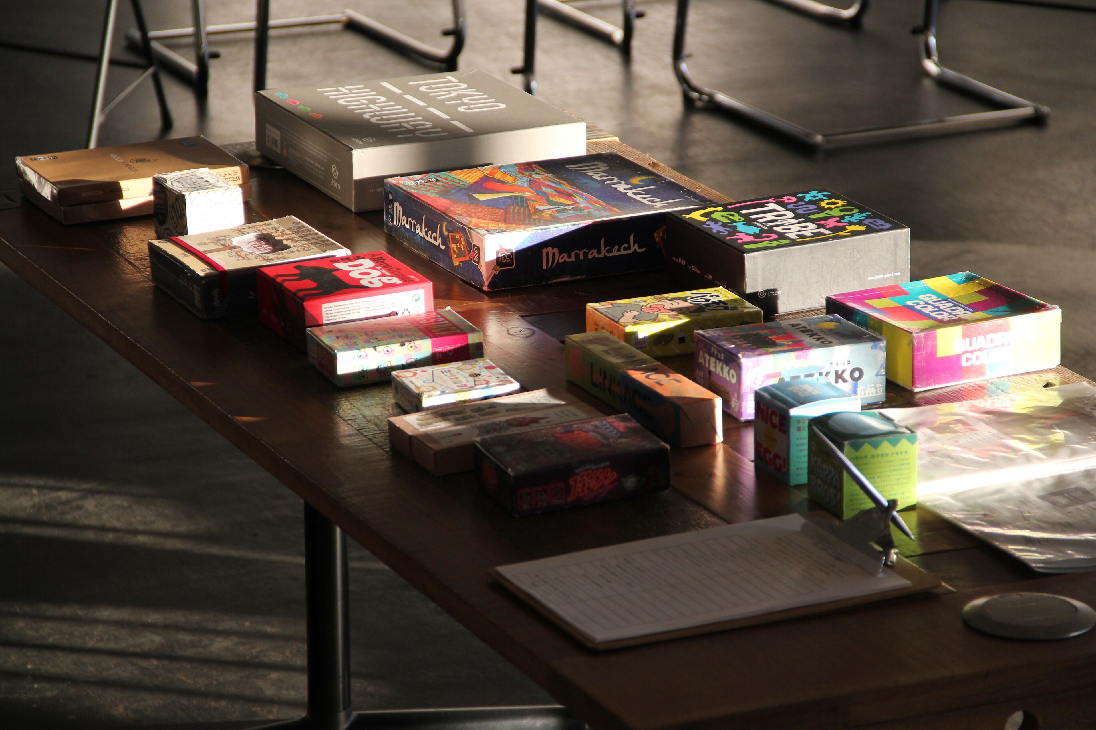 A table with various board games and a book.