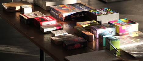 A table with various board games and a book.