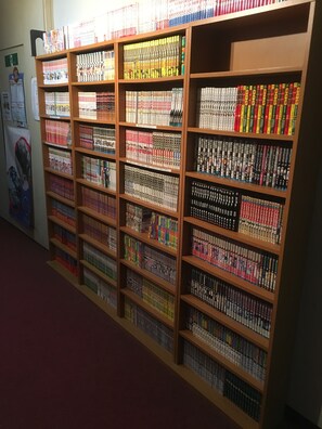 A bookshelf with multiple rows of books. - Shoraku Ryokan (Ozu)
