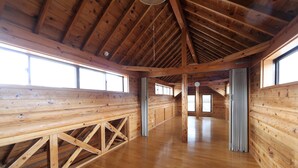 A spacious wooden cabin with high ceilings and large windows. - Oki Island Resort Island Park Hotel (Okinoshima)