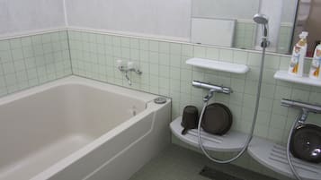 A bathroom with a bathtub, a shower, and a toilet.