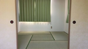 A room with tatami mat flooring, a shoji screen, and a green curtain. - Heartland Hills in Noto 5 Ike no Hotori House (Shika)
