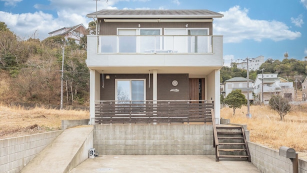 A two-story building with a balcony, a small staircase, and a visible door. - Fukuroan (Shirahama)