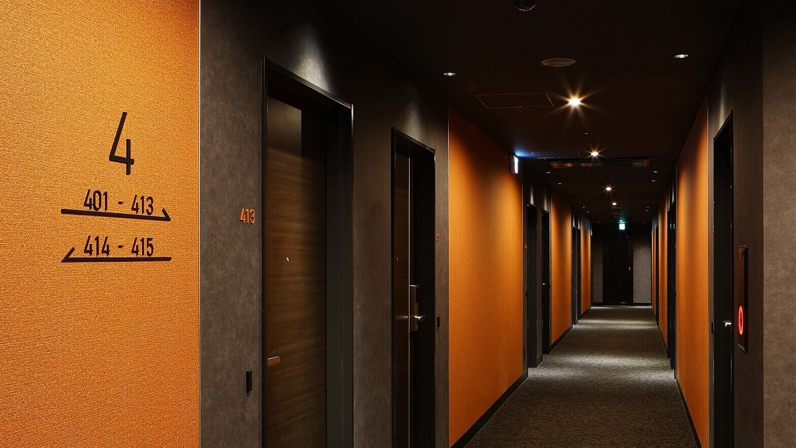 A hotel corridor with doors numbered 4, 401-413, and 414-415.