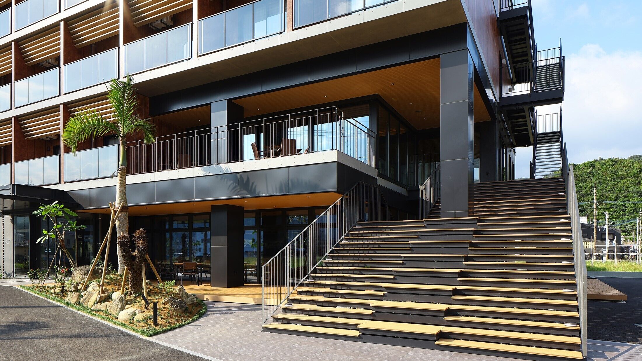 A multi-story building with a modern architectural design, featuring a staircase leading to the upper levels.